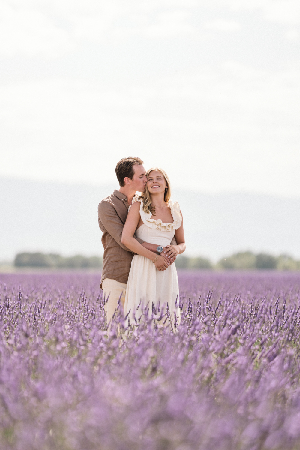 man kisses woman on the side of her hair in provence