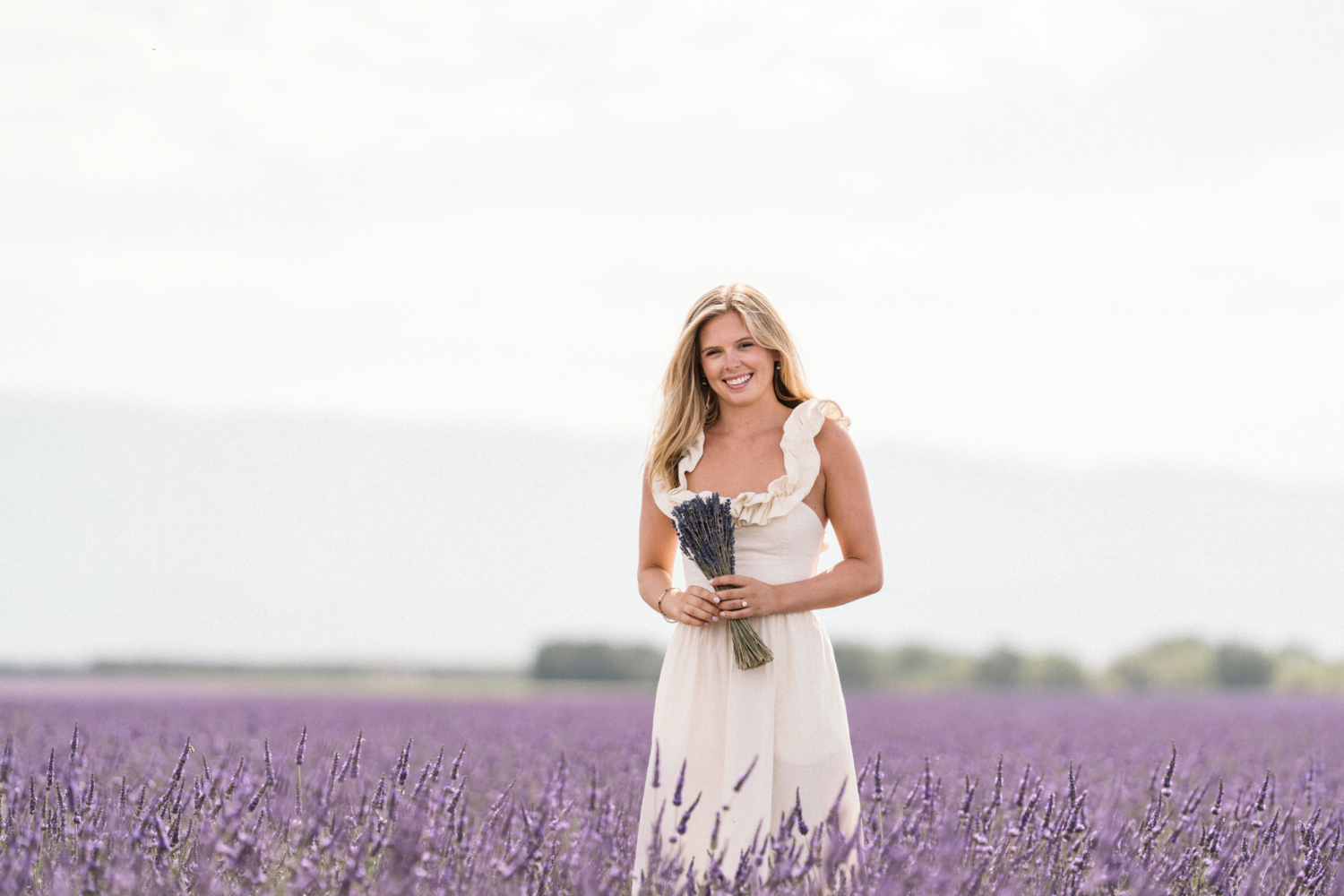 engaged woman holds lavender bouquet