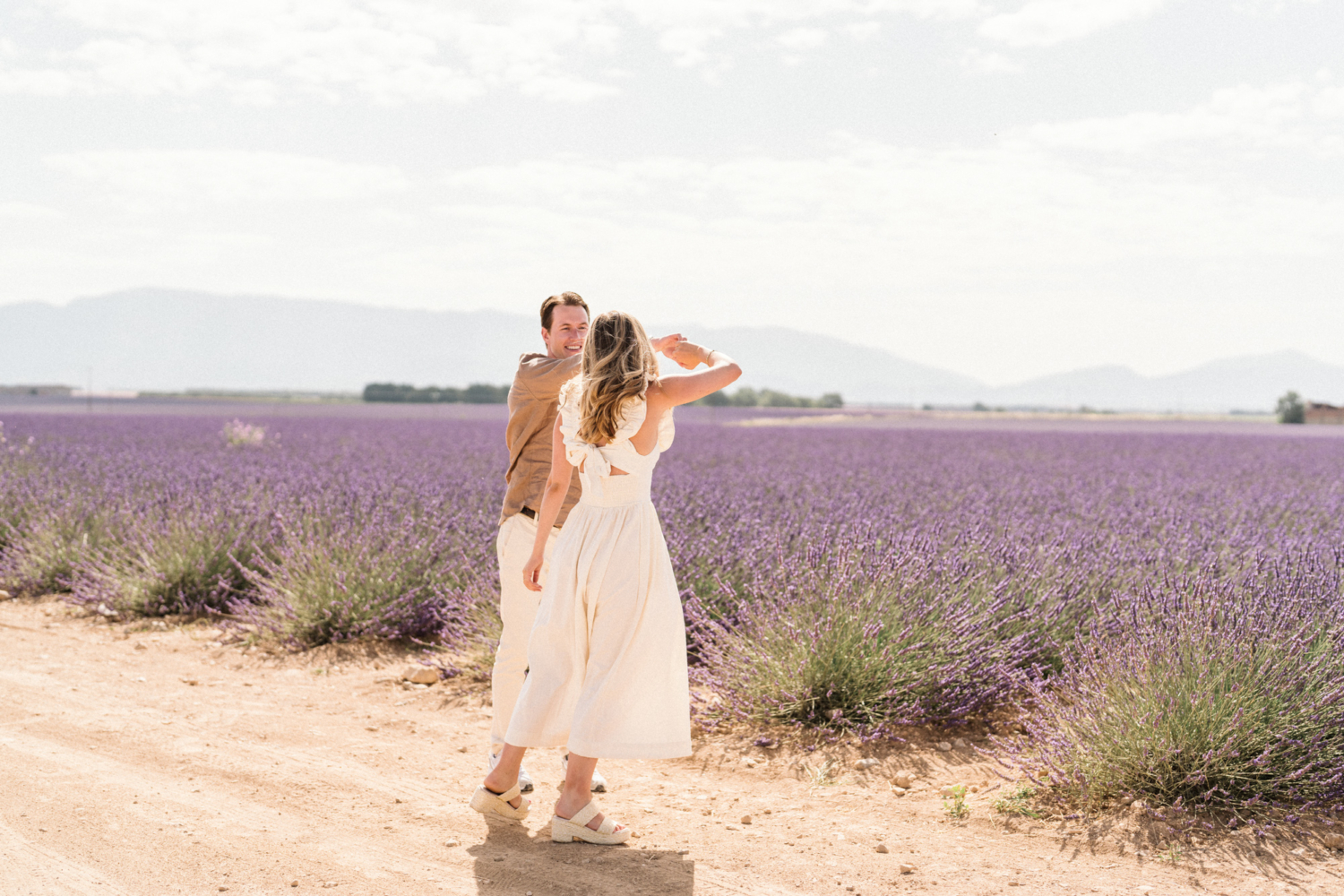 engaged couple dance in lavender field