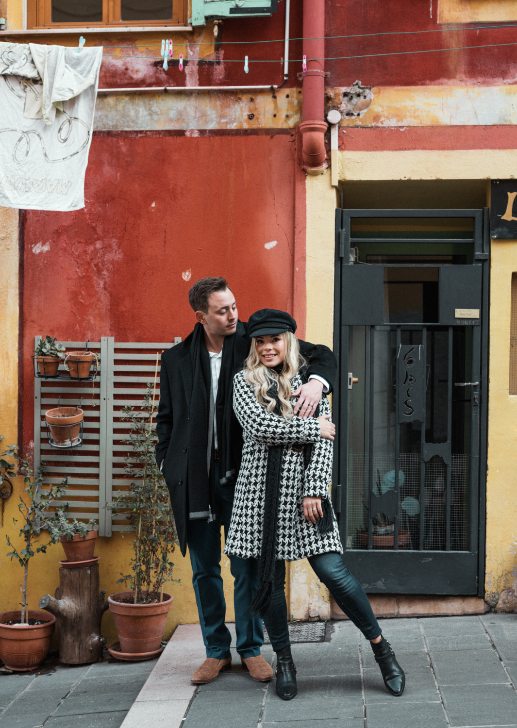 cute couple pose in winter in old town nice france