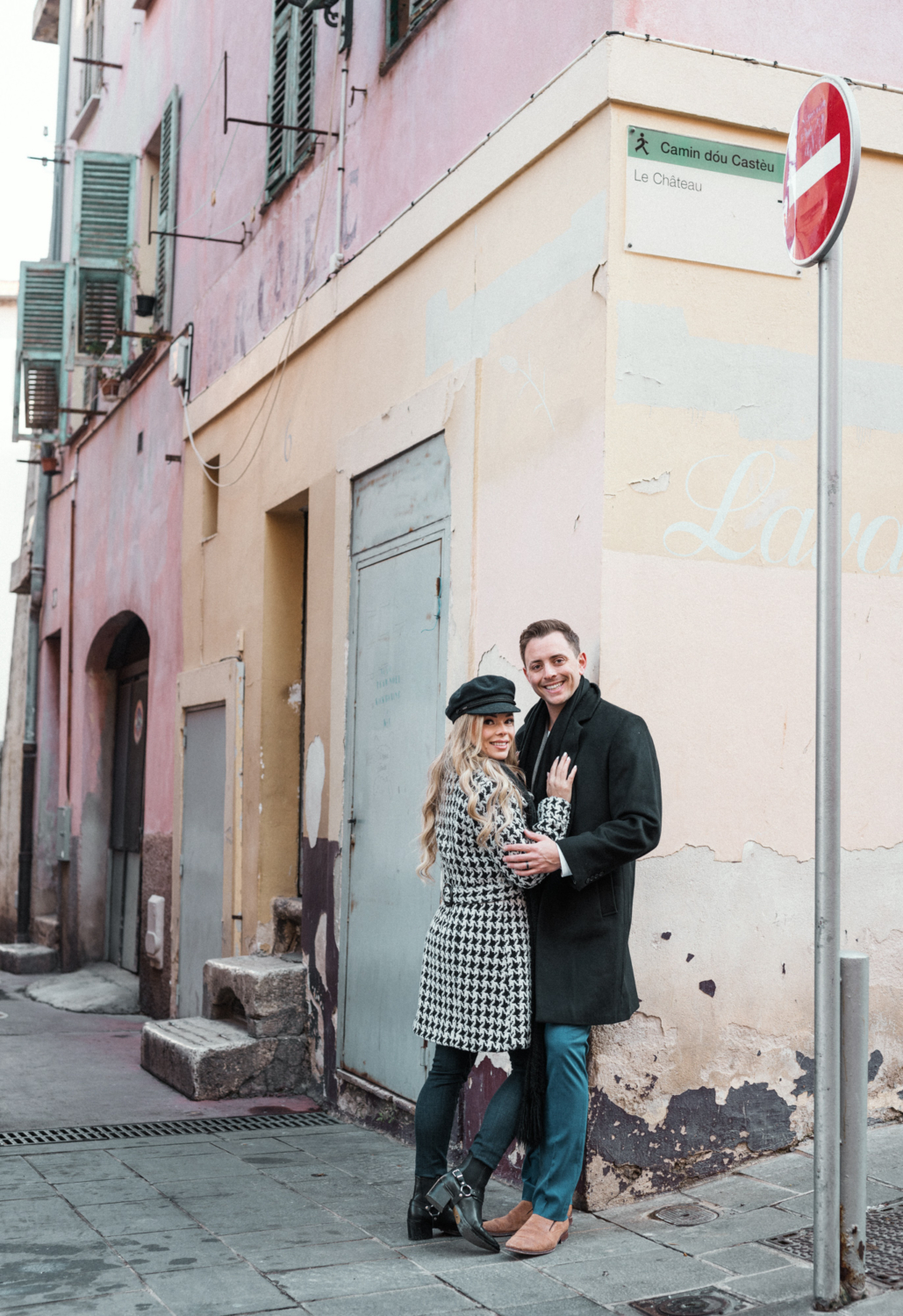 cute couple pose in winter attire in nice france