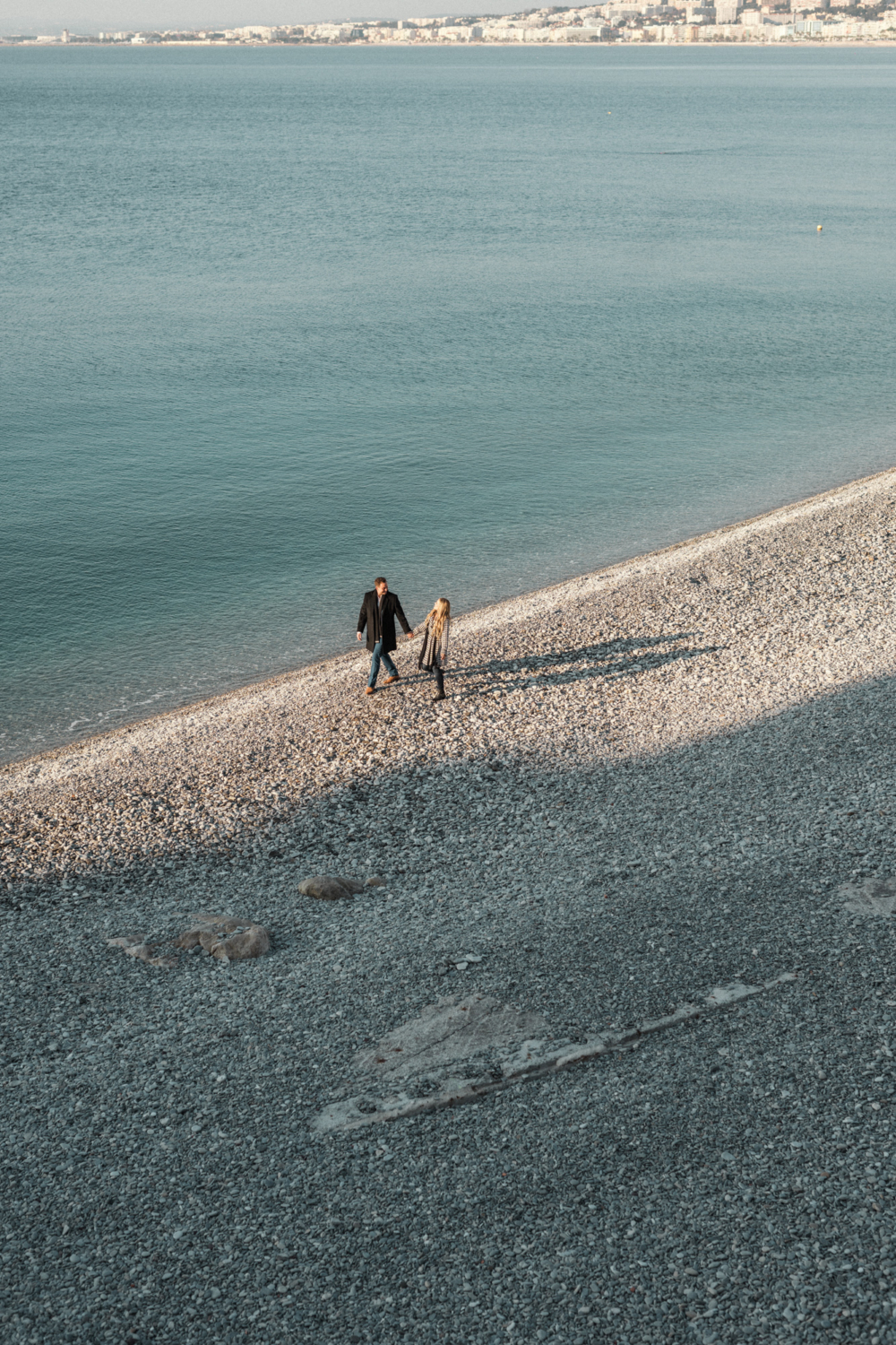 newlywed couple walk on beach in winter in nice france