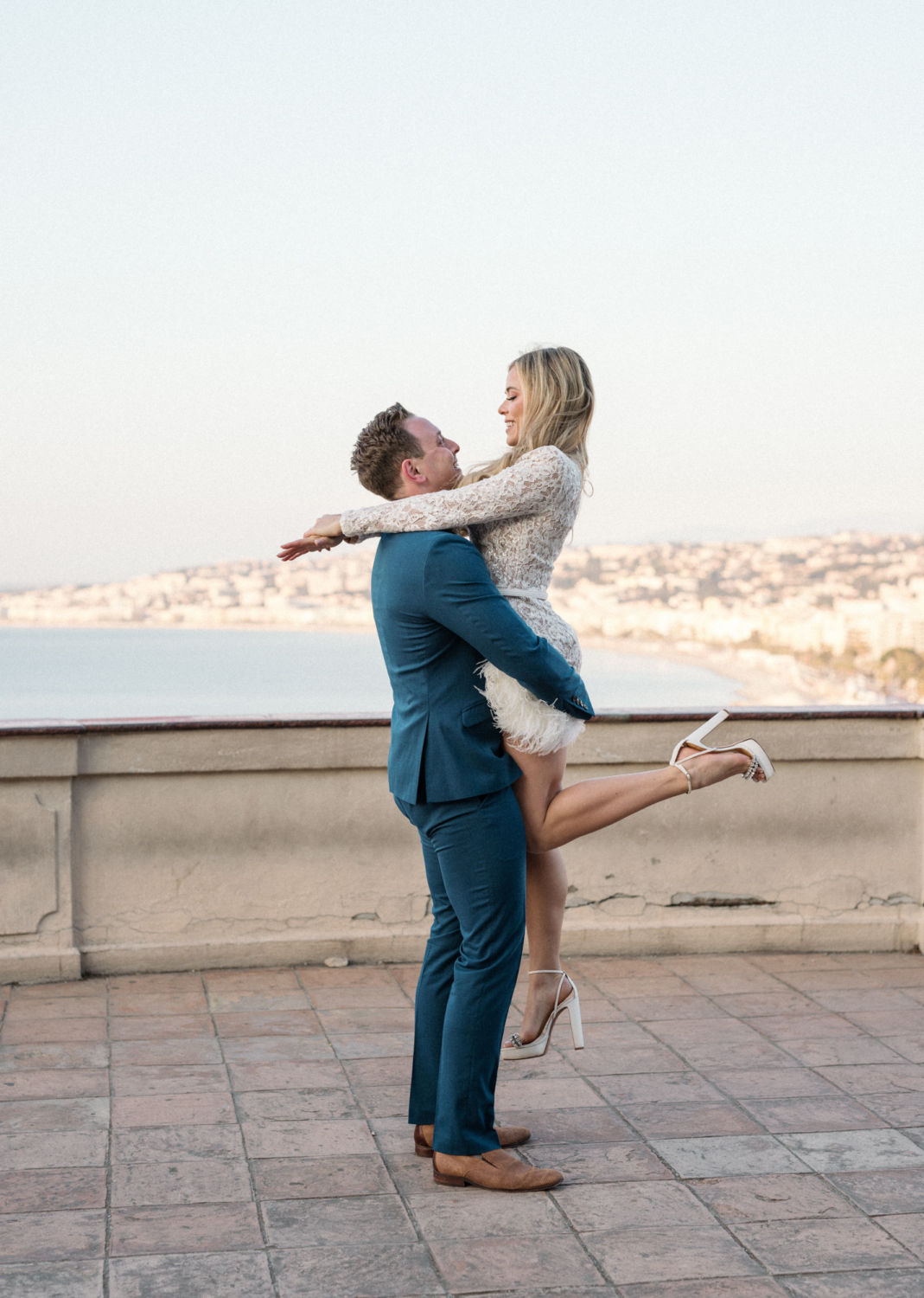 man lifts woman in air in nice france