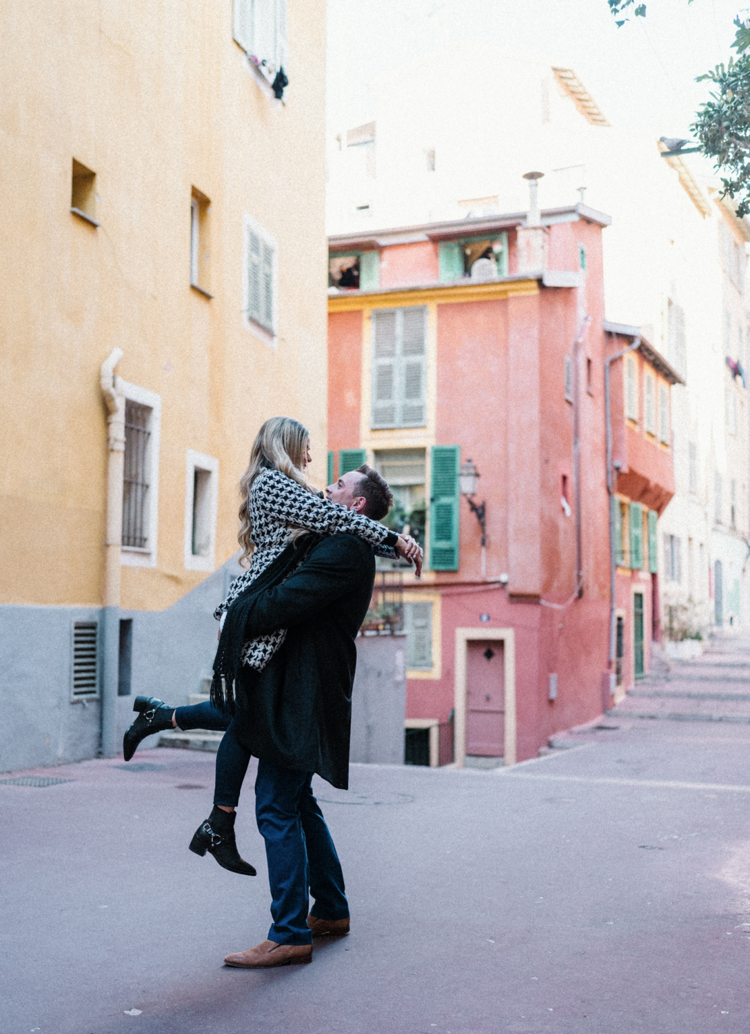 man lifts woman in old town nice france