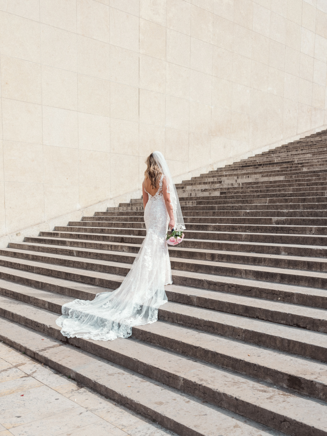 bride poses on staircase in paris france