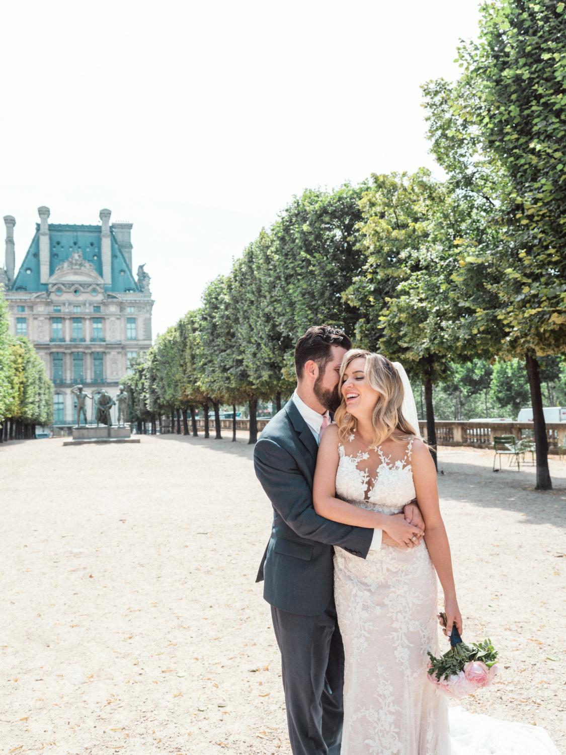 bride and groom laugh in tuileries gardens paris