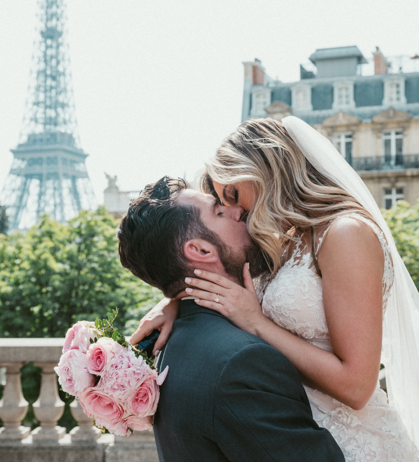 bride and groom passionately kiss in paris