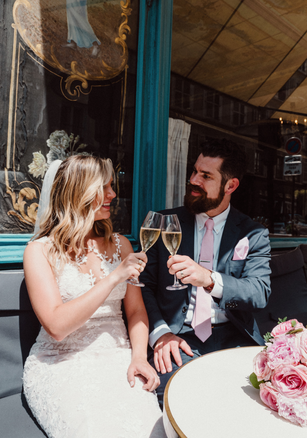 bride and groom toast each other with champagne