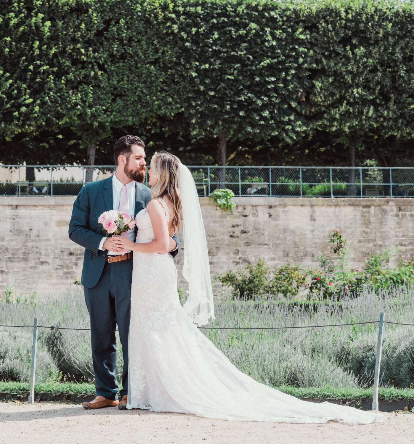 bride and groom pose in the tuileries gardens paris
