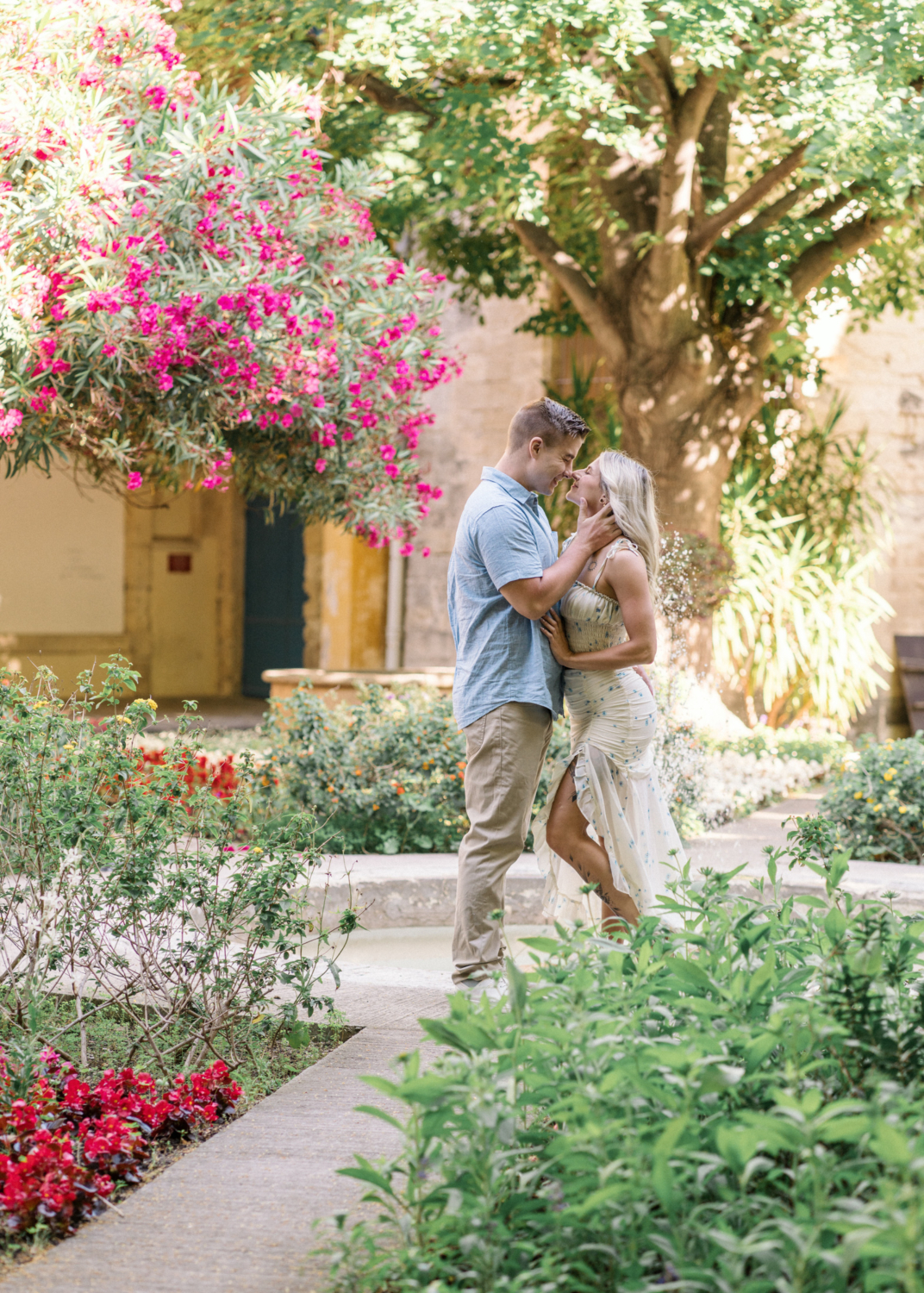 young engaged couple embrace tenderly in garden in arles france