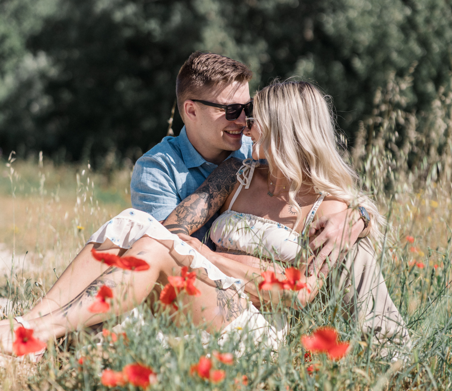 young engaged couple embrace in poppy field in arles france