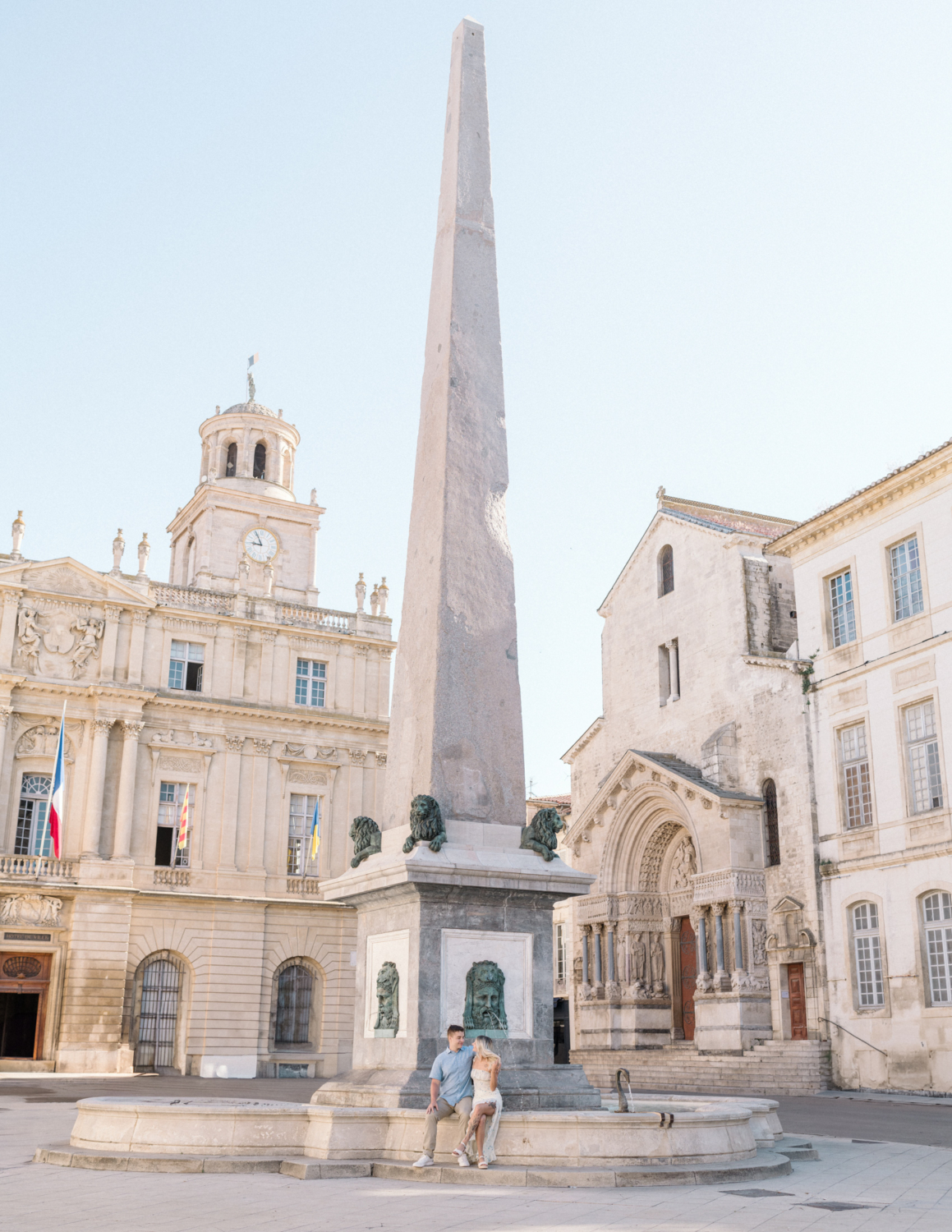 young engaged couple pose at obelisk in arles france