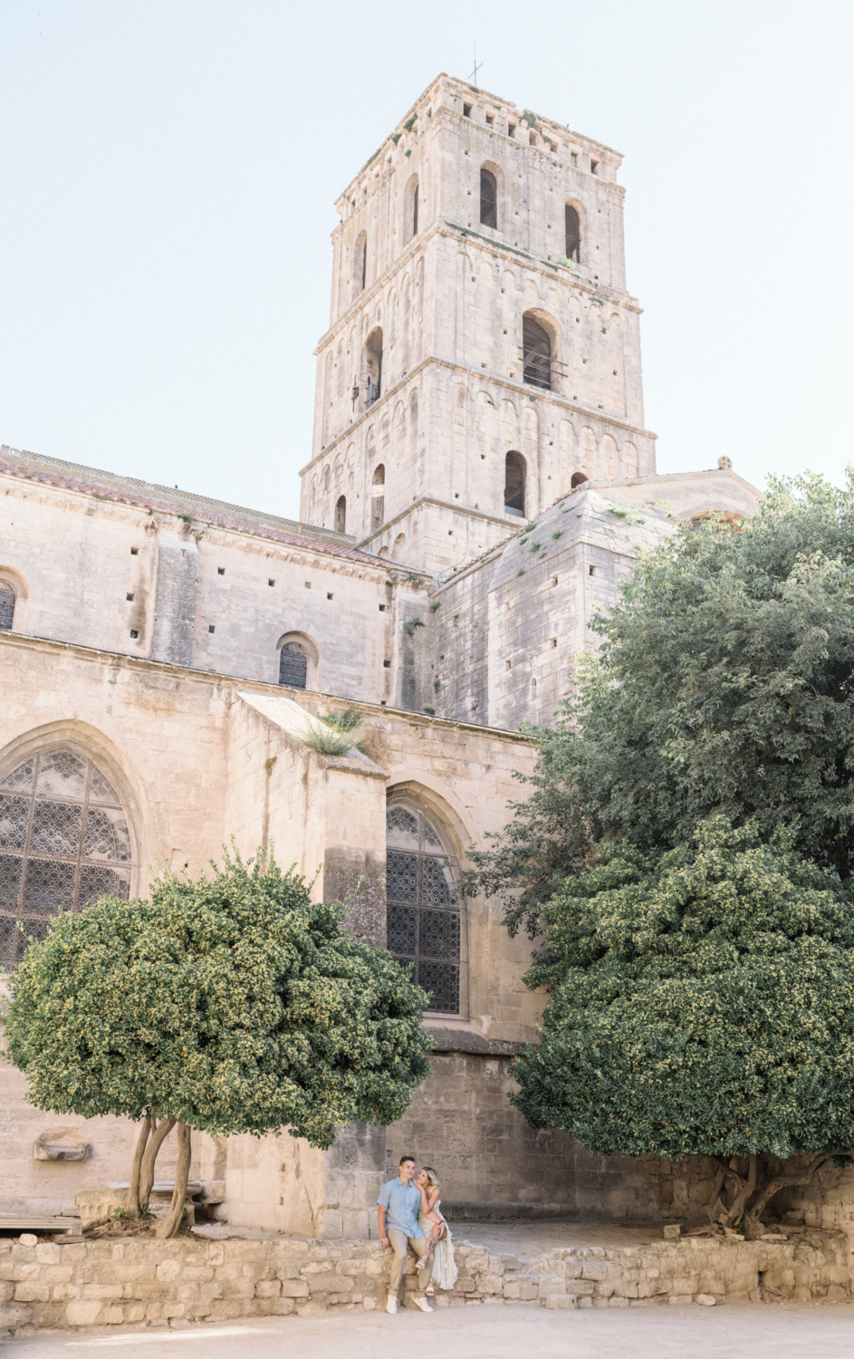 young engaged couple pose outside saint trophime church in arles france