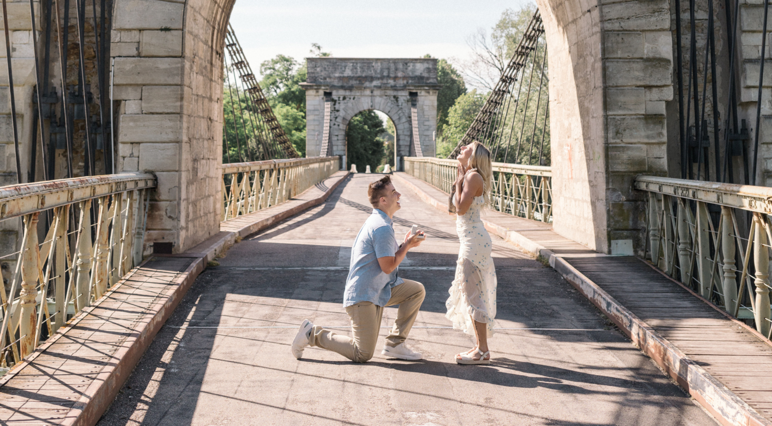 man on one knee presents engagement ring to woman in arles france