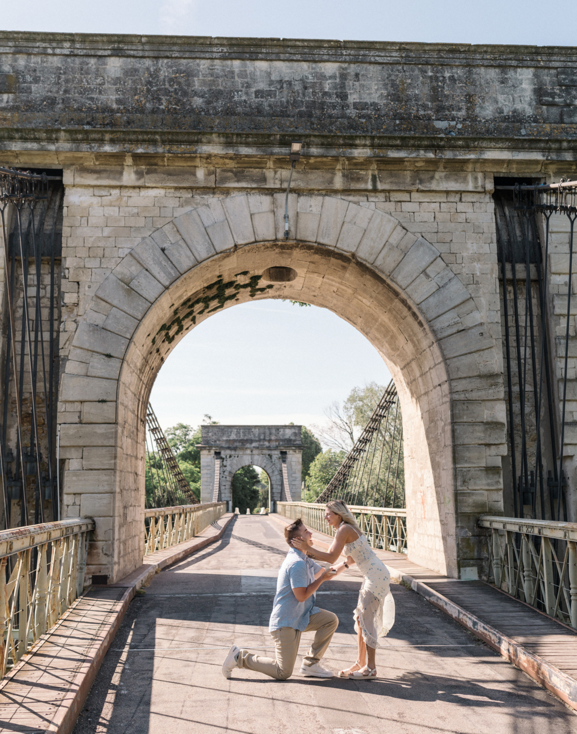 man on one knee proposes marriage to woman in arles france