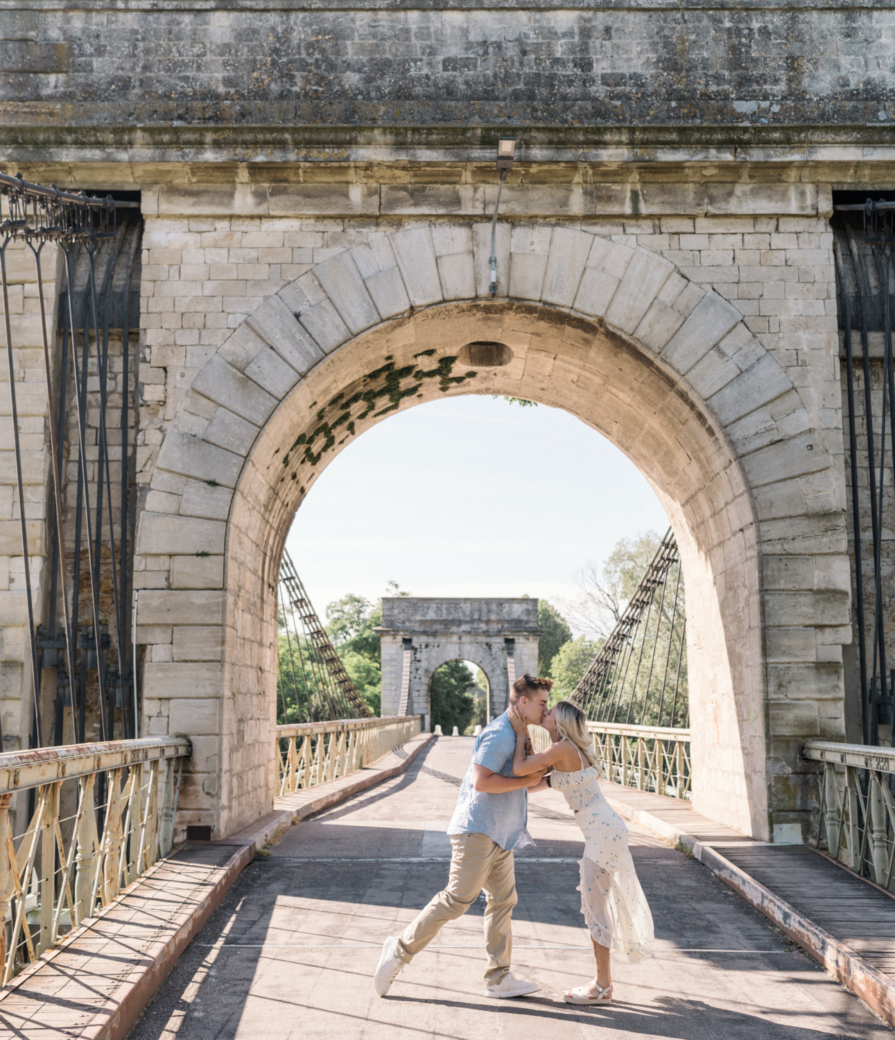 young engaged couple kiss after their engagement in arles france