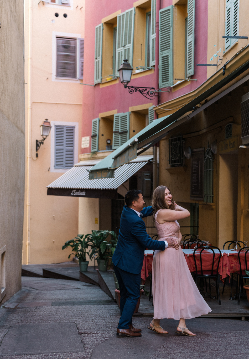 couple dance and laugh in old town in nice, france