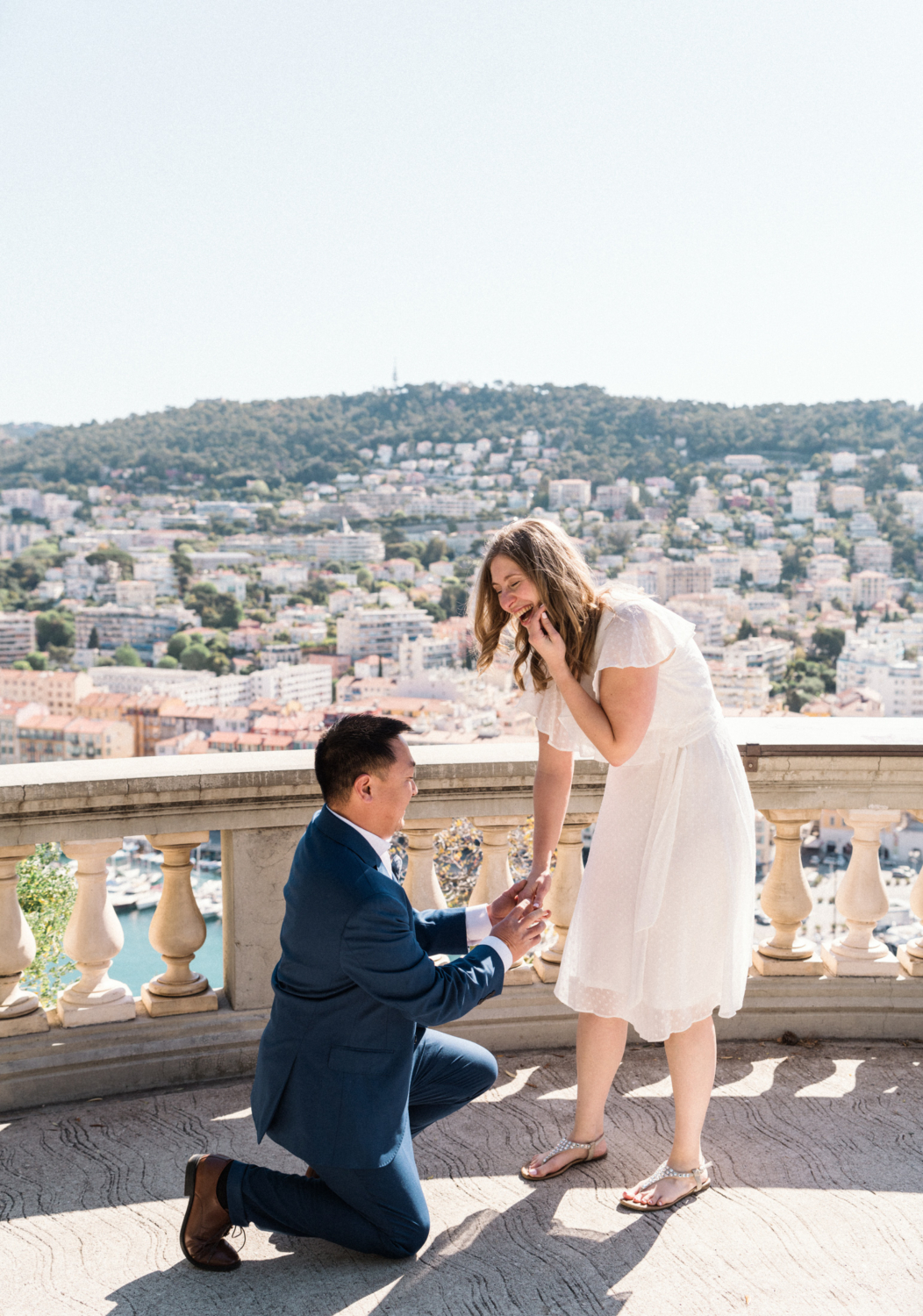 woman laughs during surprise proposal in nice, france