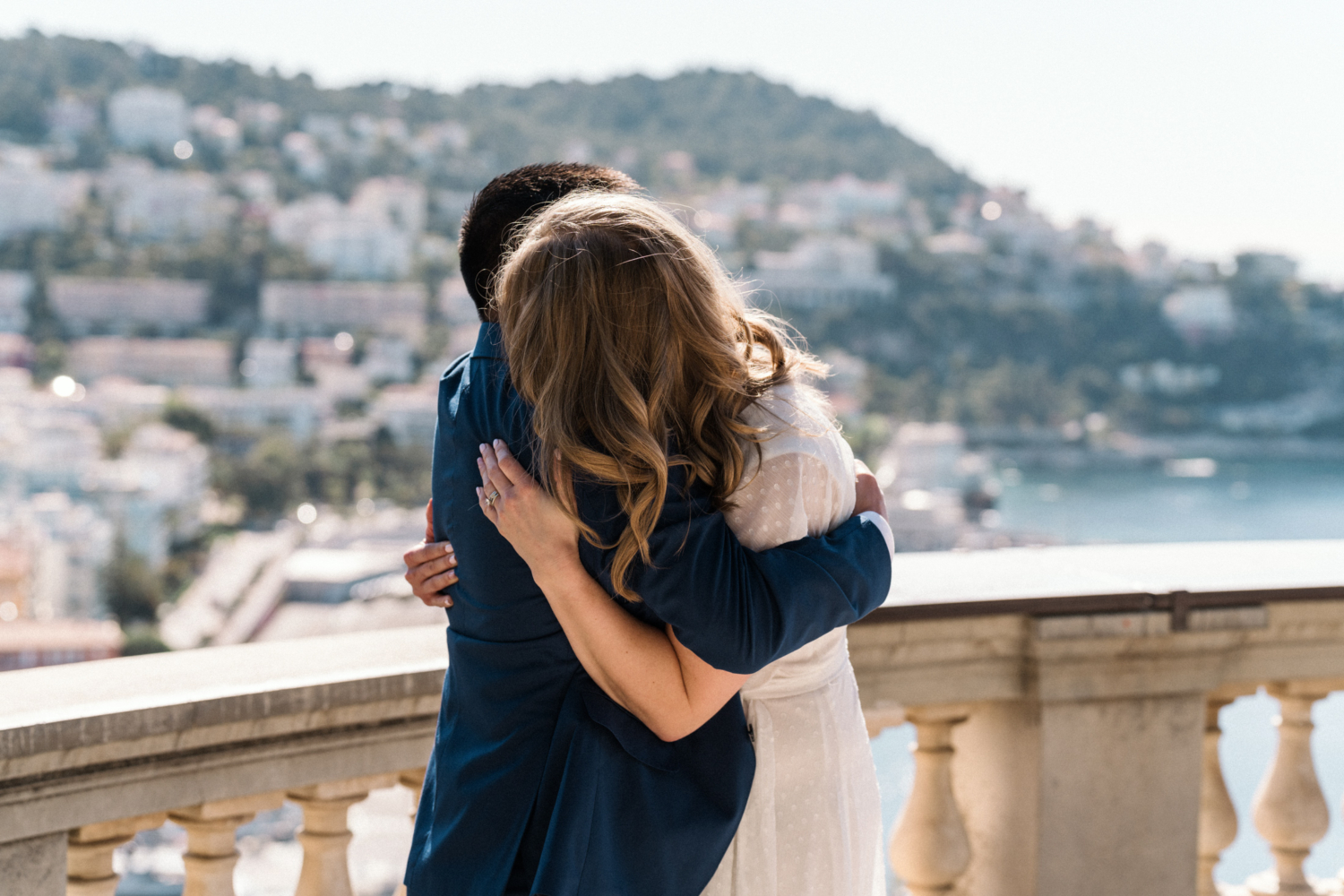 couple embrace after surprise proposal in nice, france
