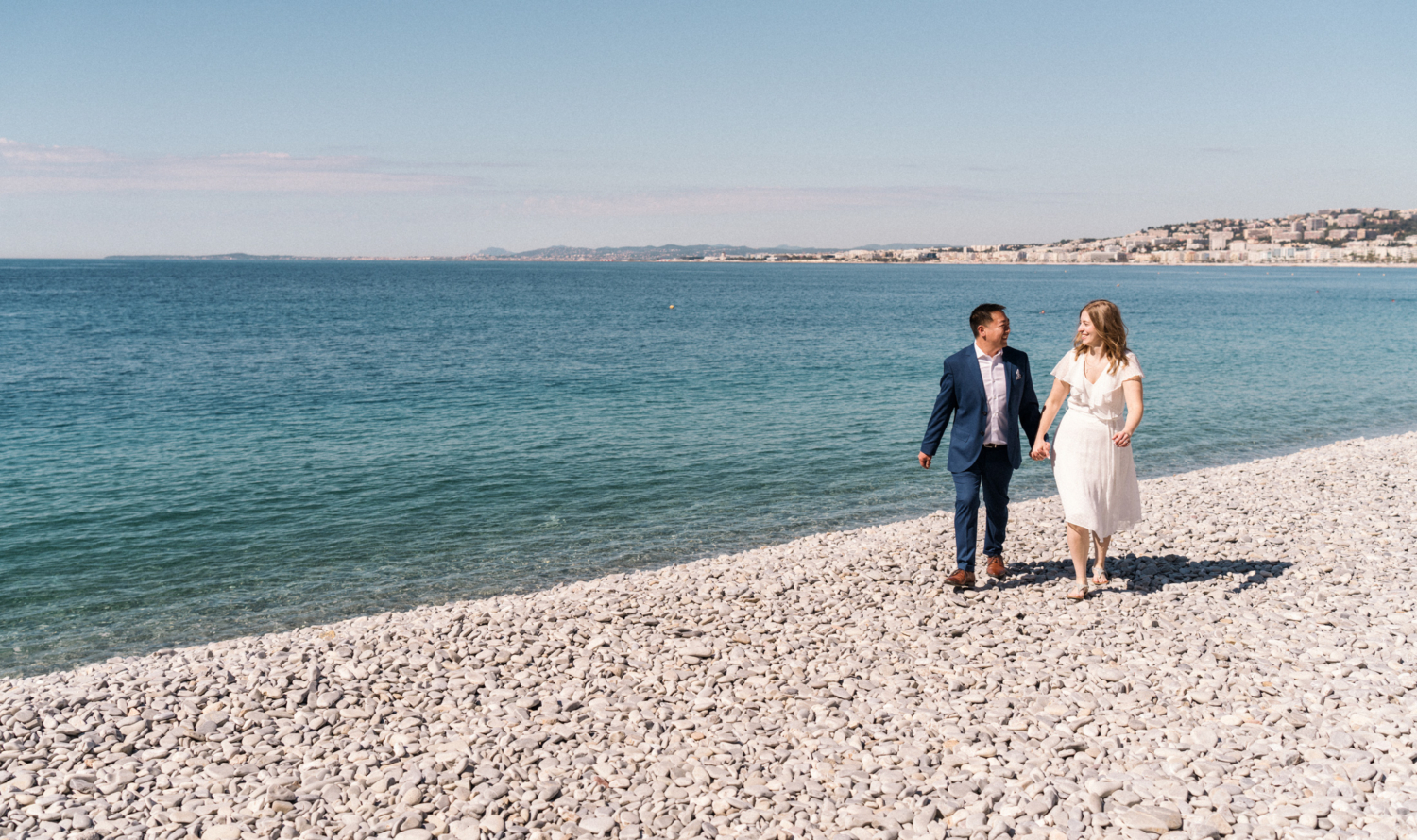 newly engaged couple walk on the beach nice, france