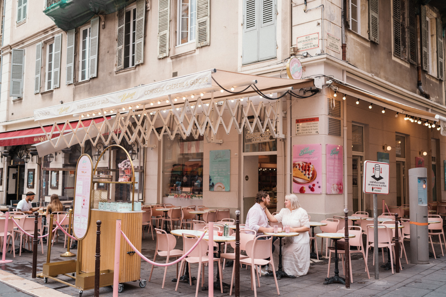 couple sharing tender moment at cafe in nice france