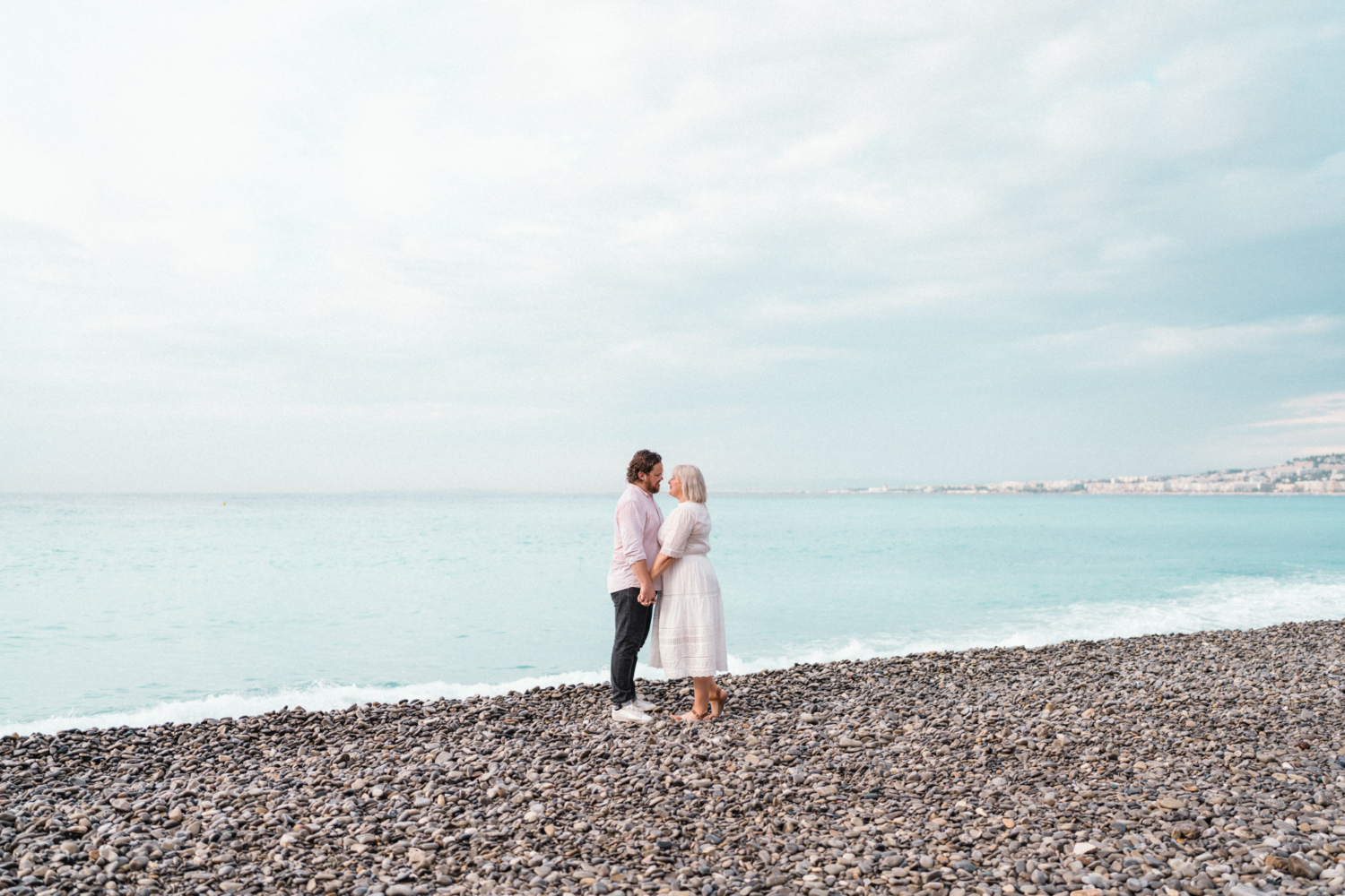 cute couple hold hands on the beach in nice france