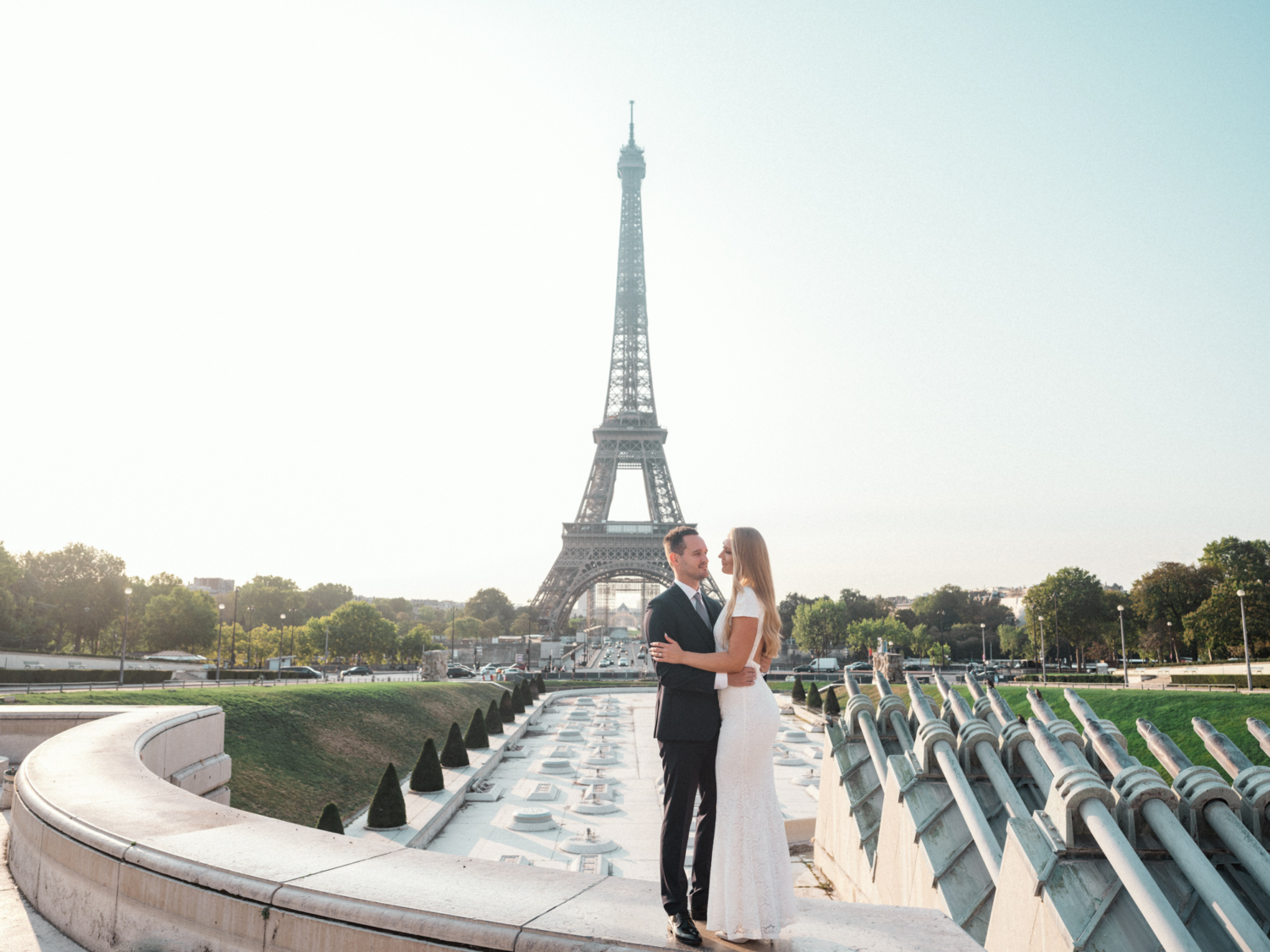 bride and groom pose at eiffel tower paris france