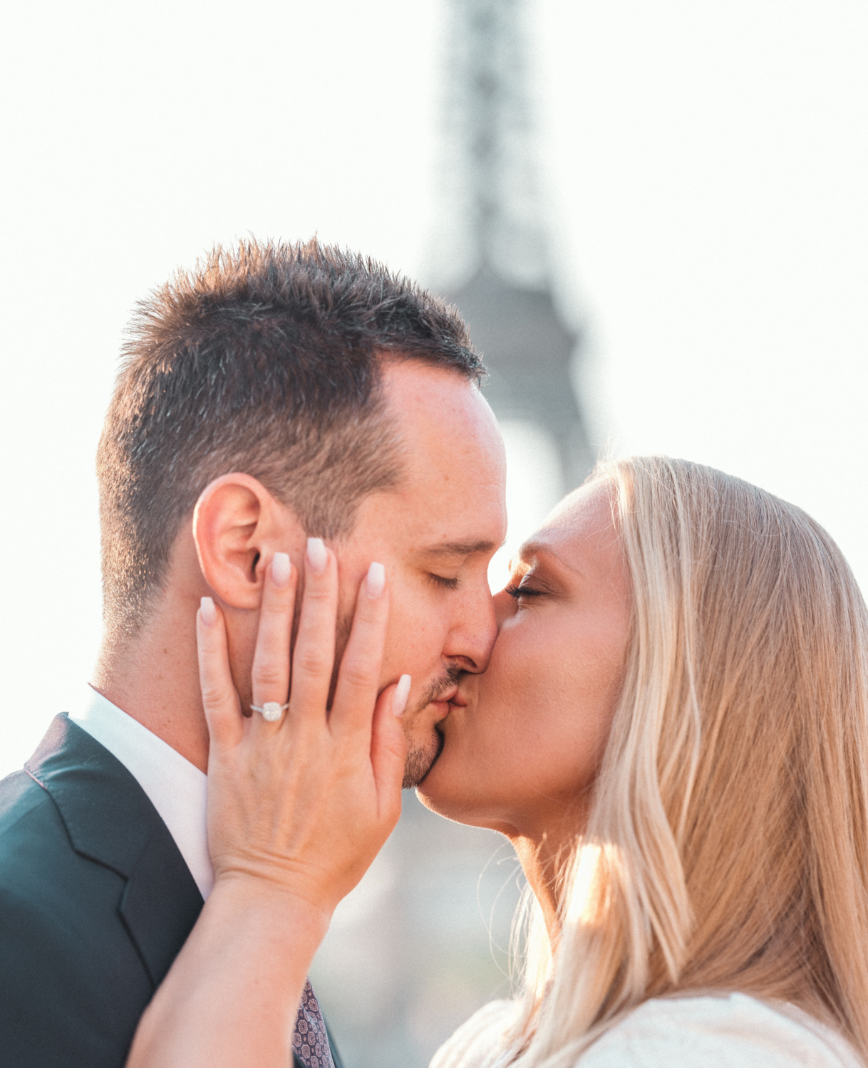bride and groom in a tender kiss with eiffel tower view