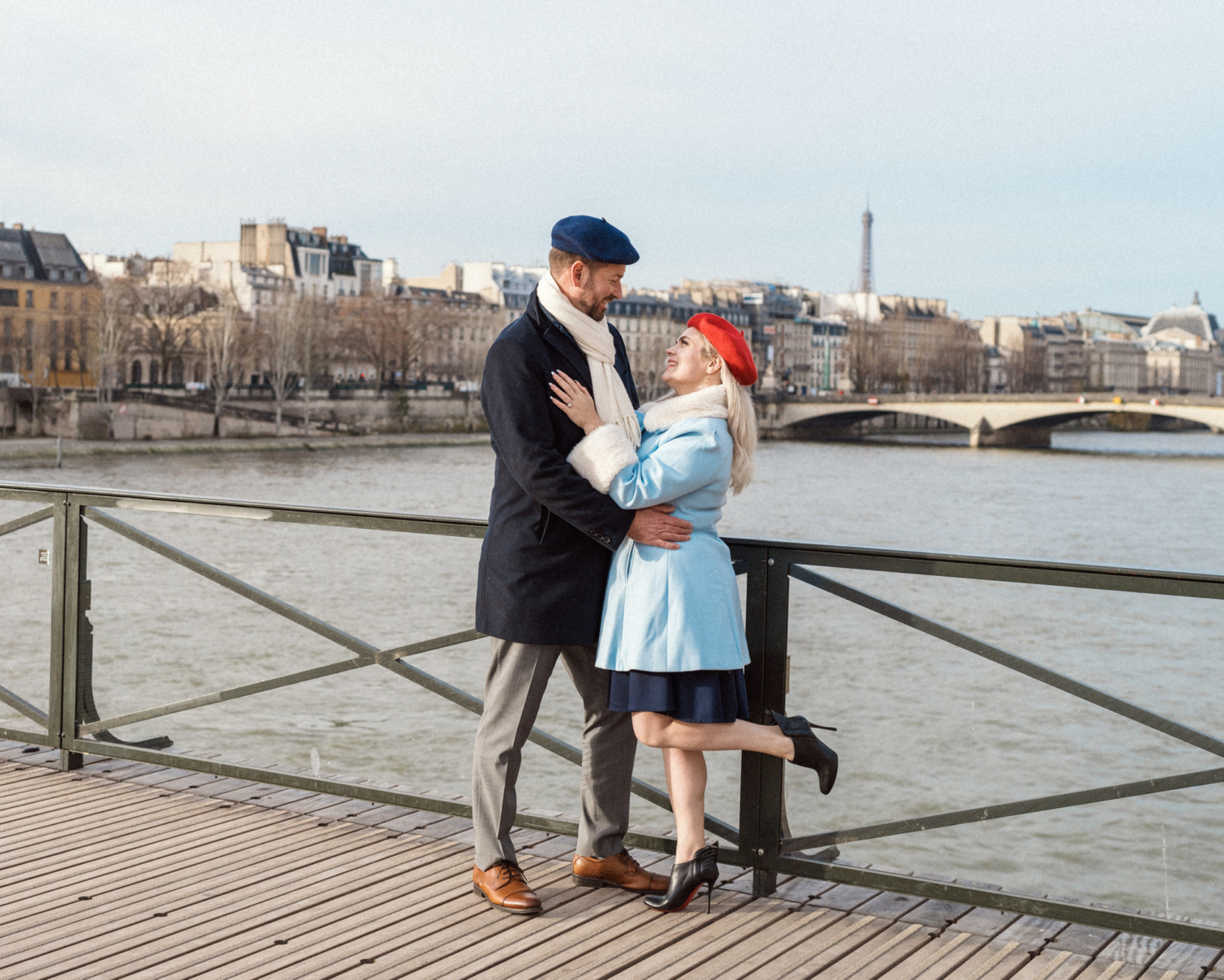 man and woman in beret embrace in paris