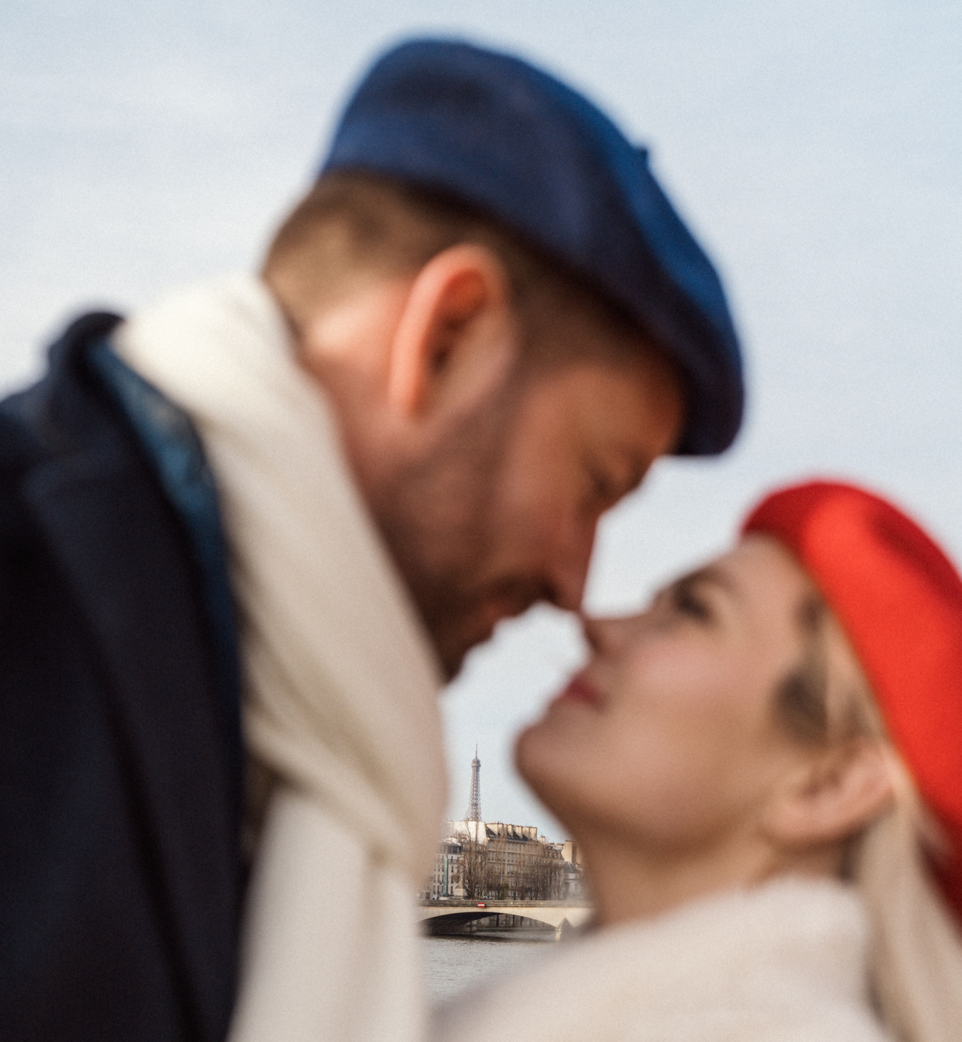 couple in paris embrace with eiffel tower in background