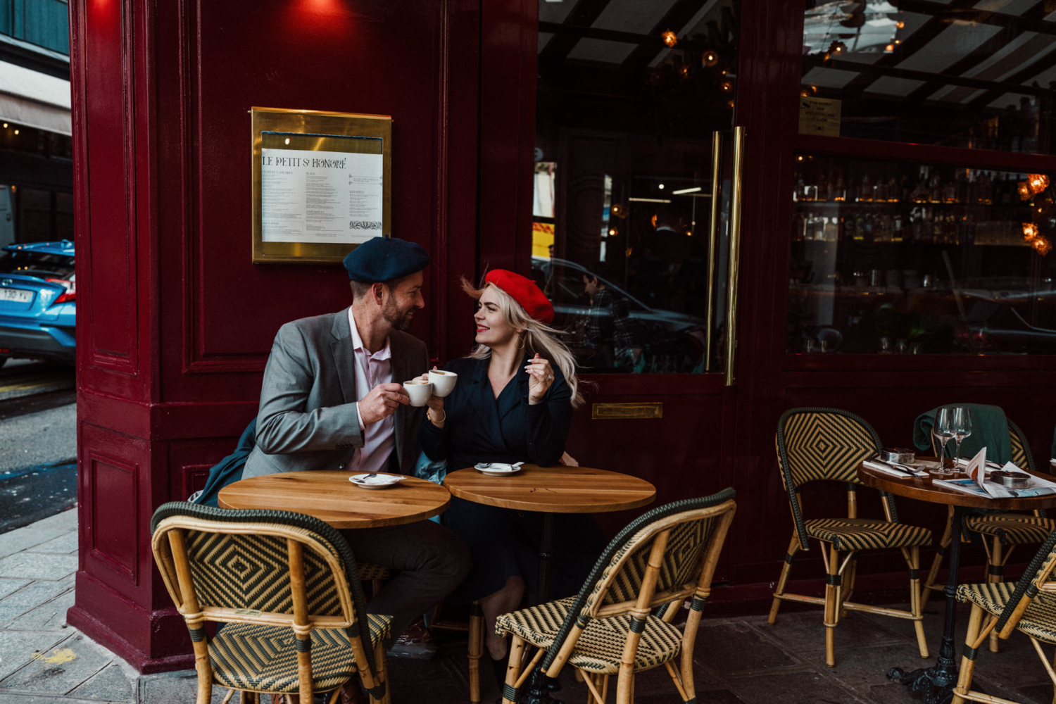 man and woman cheer each other with coffee in paris