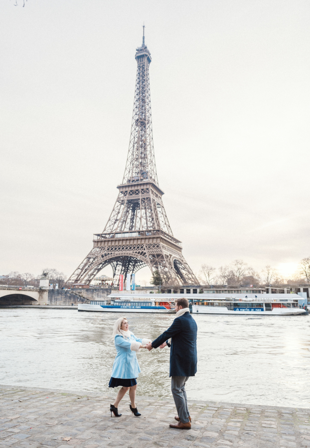 engaged couple dance at eiffel tower in paris