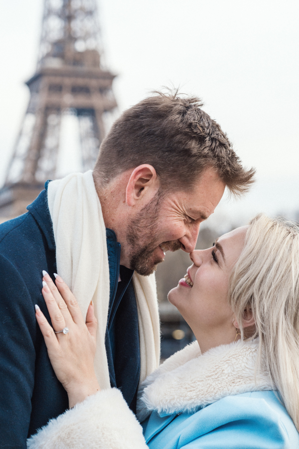 couple nose to nose with eiffel tower in background