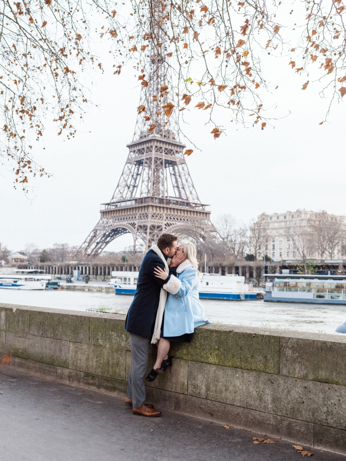 engaged couple kiss in paris with view of eiffel tower