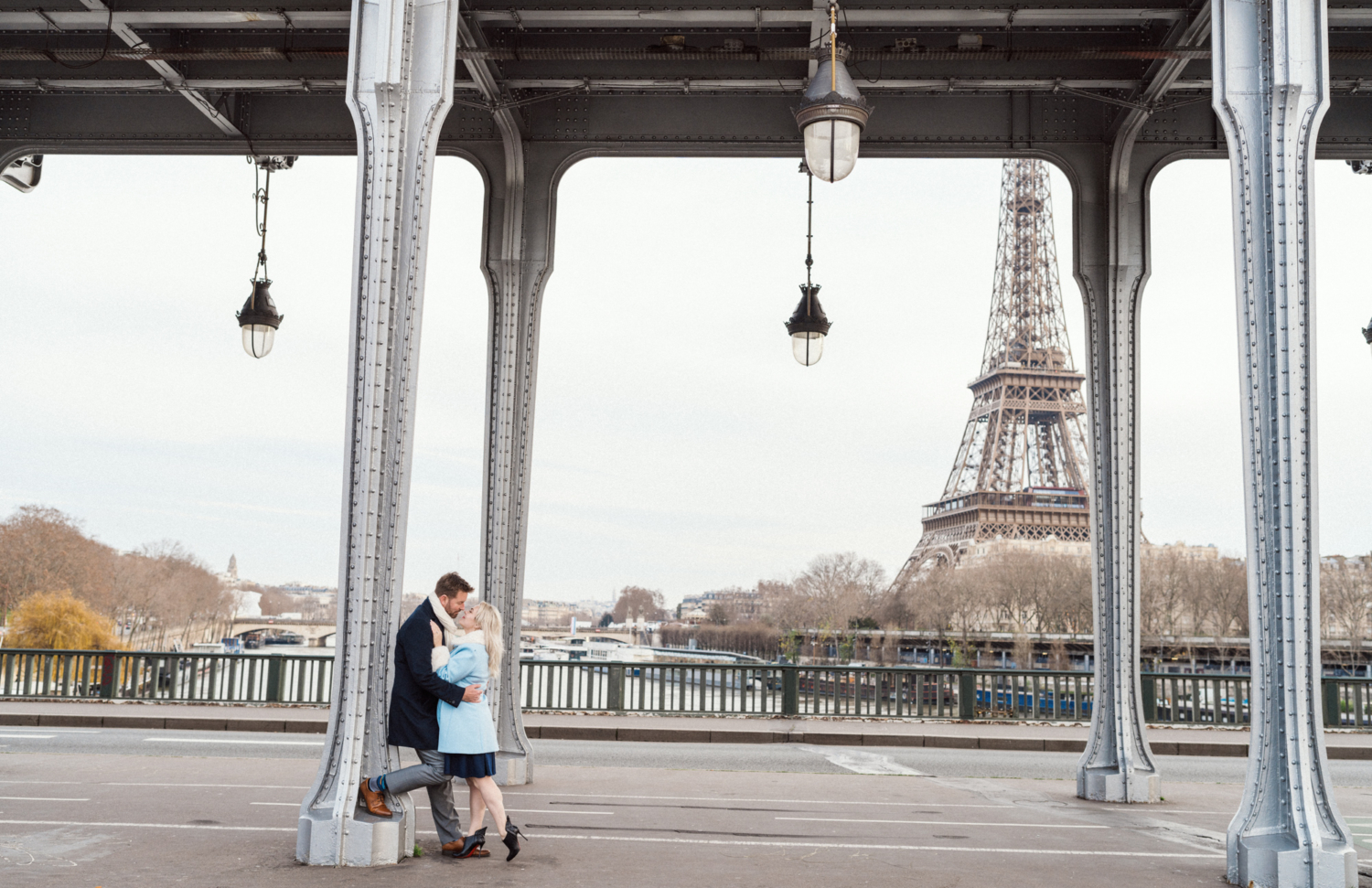 couple embrace with view of the eiffel tower in paris