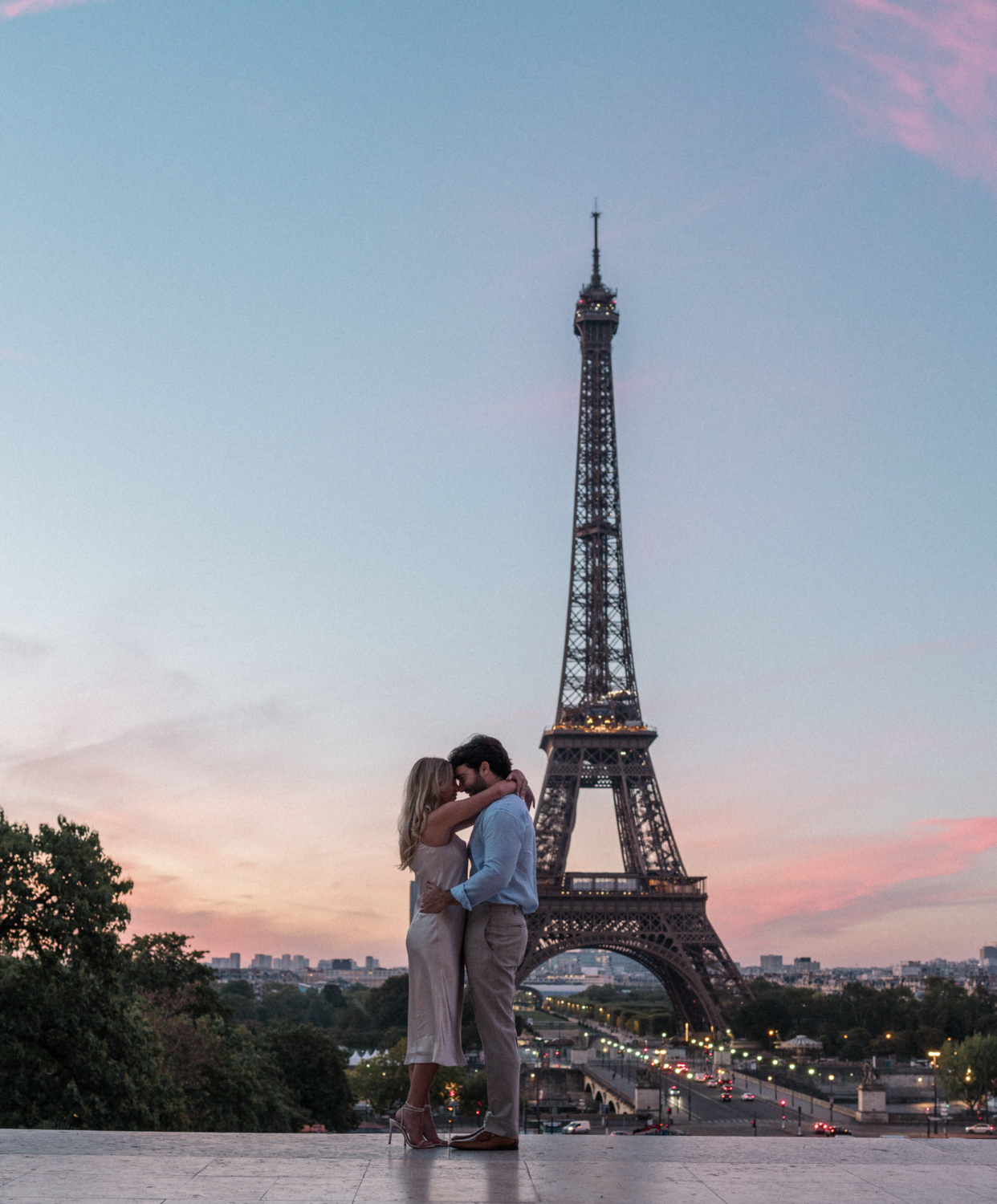 engaged young couple embrace at sunrise at trocadero eiffel tower