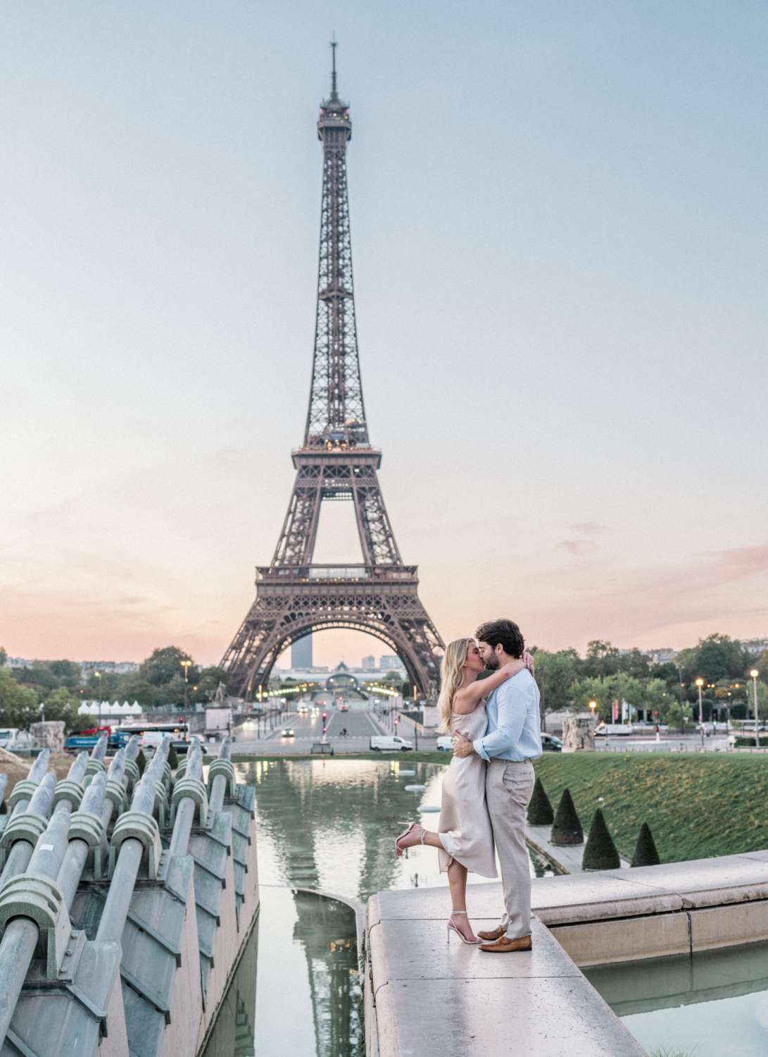 engaged young couple kiss passionately at trocadero eiffel tower
