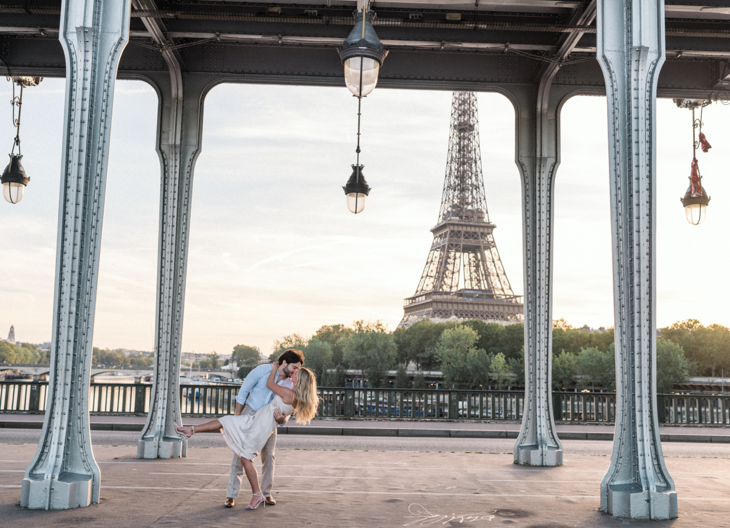man dips woman at sunrise at the eiffel tower in paris
