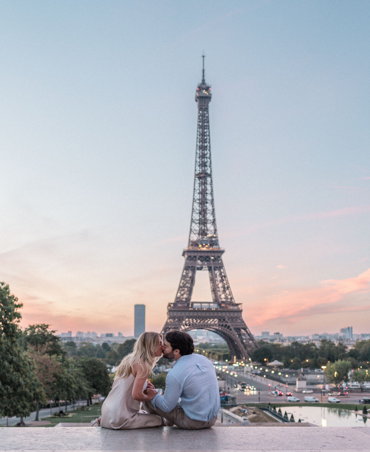 engaged young couple kiss at sunrise at the eiffel tower paris