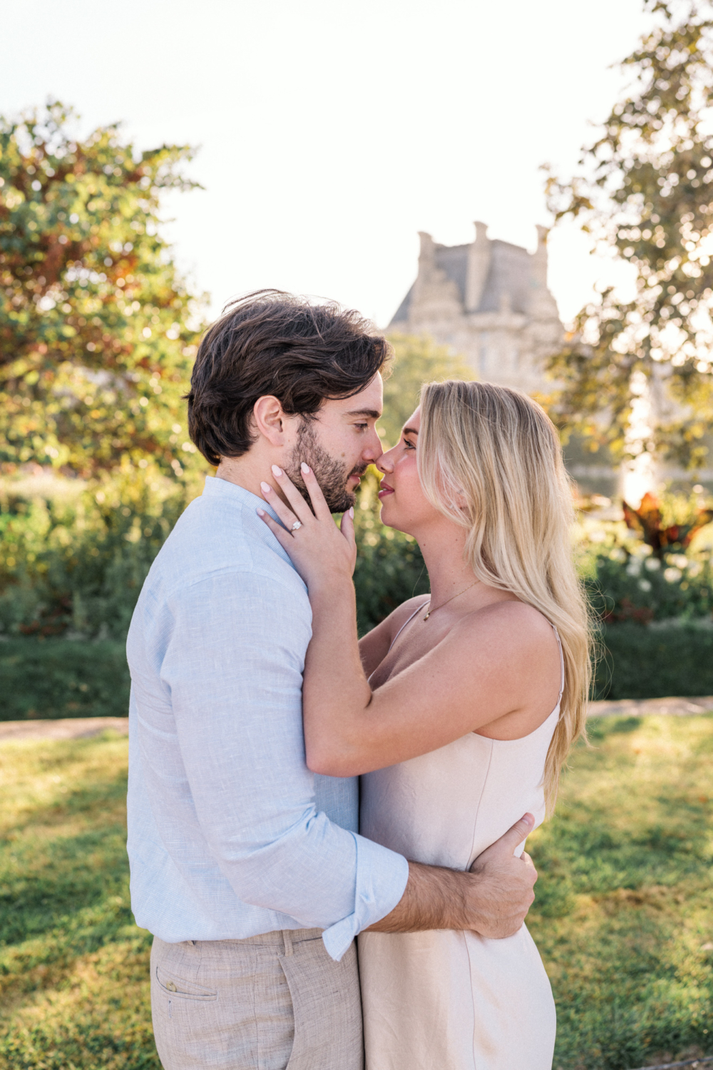 engaged young couple embrace at tuileries gardens in paris