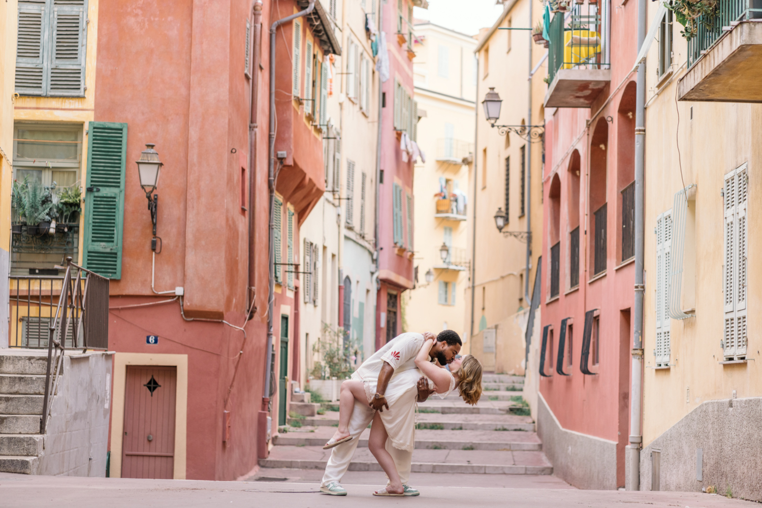 man dips woman and kisses her in old town nice france