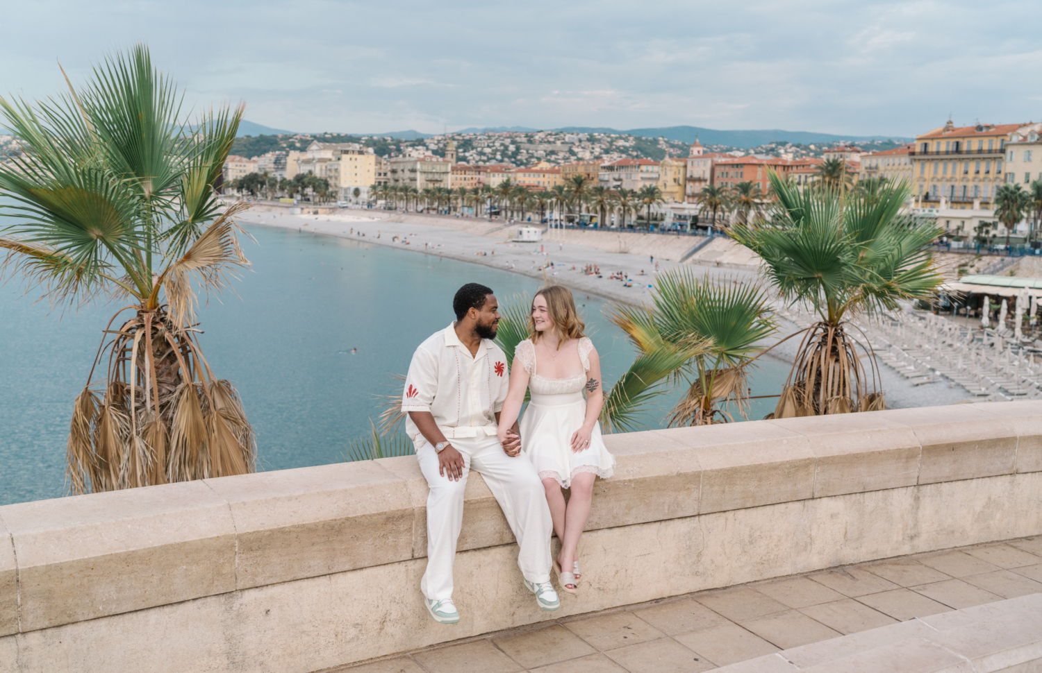 cute newlywed couple pose with view of the sea in nice france