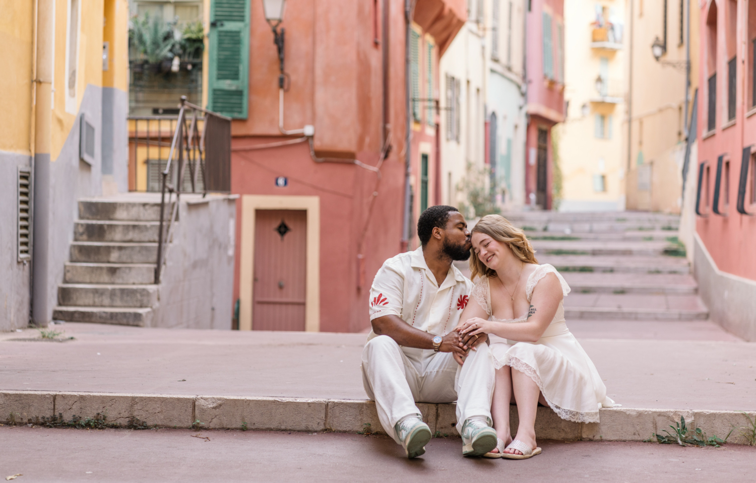 man kisses wife on side of head in old town nice france