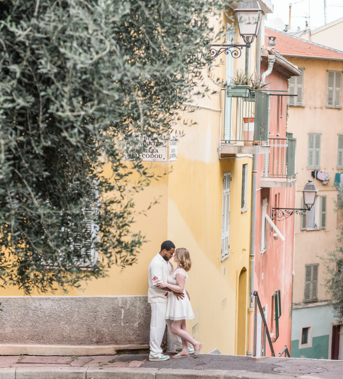 newly married couple embrace in old town nice france