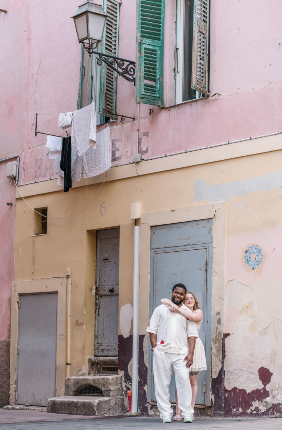 cute honeymooning couple embrace in old town nice france