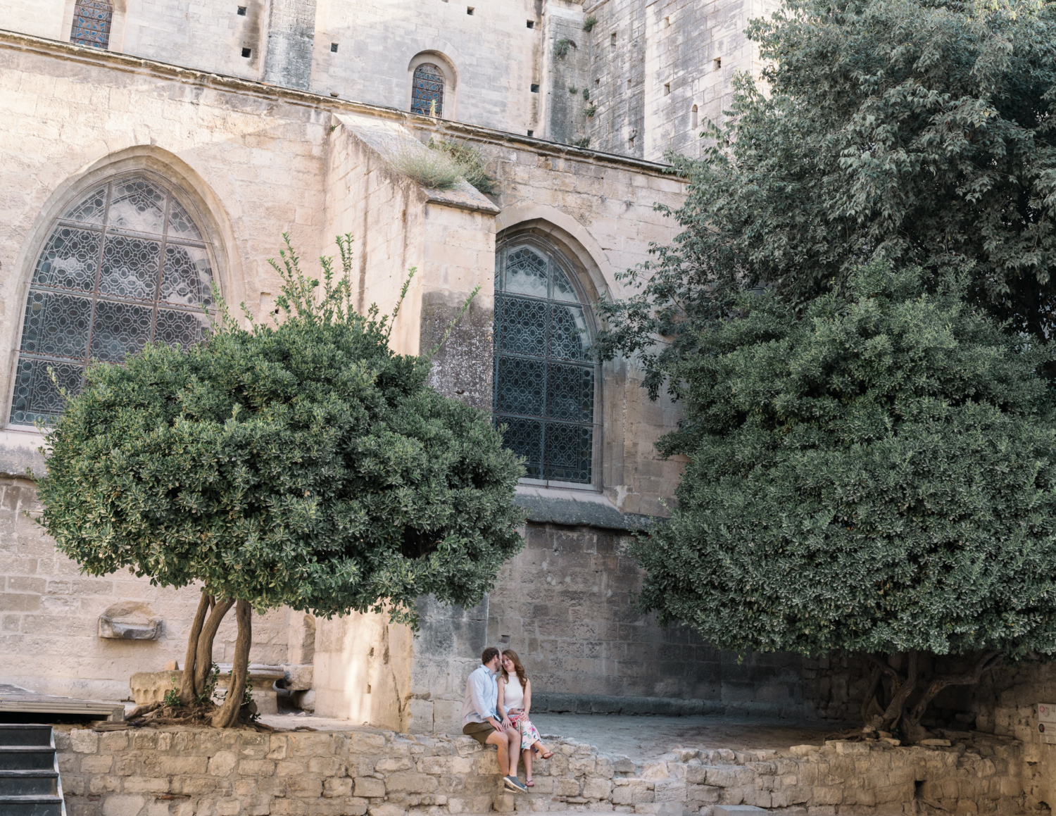 beautiful couple sit outside church of st trophime in arles france