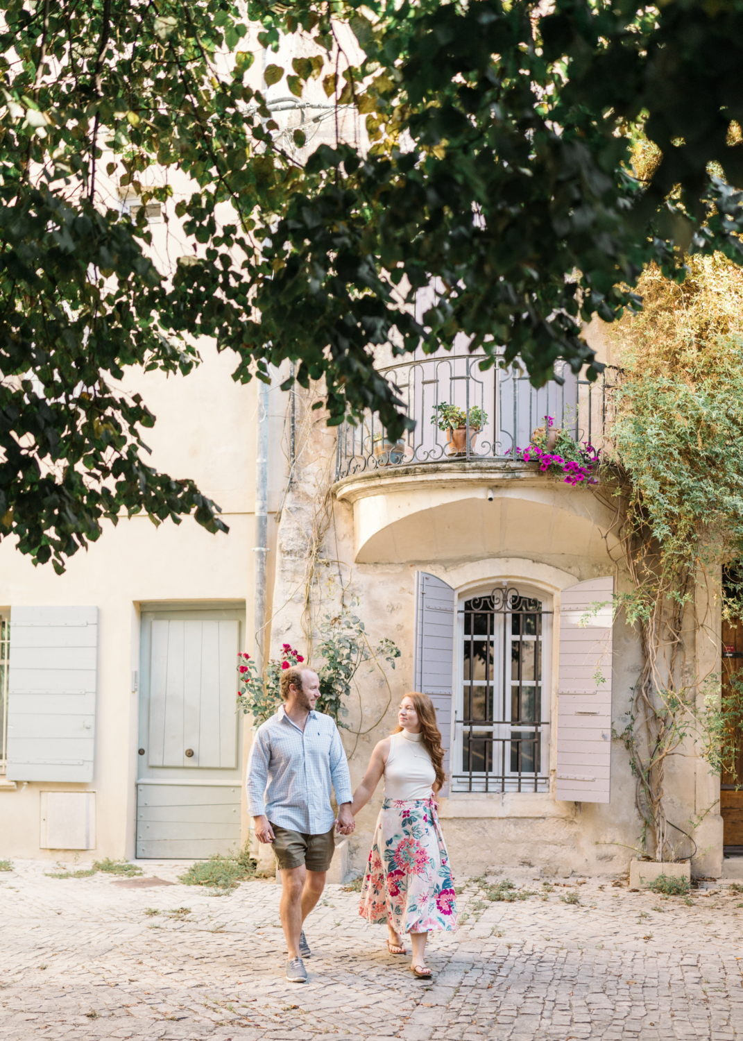 couple couple walk hand in hand in charming neighborhood in arles france