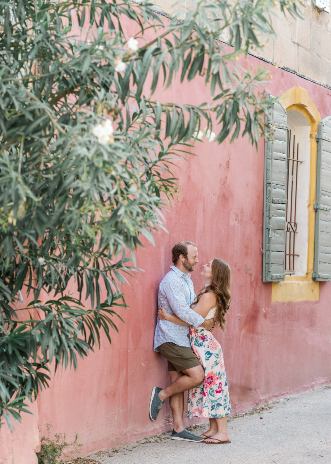 beautiful couple embrace on the side of a building in arles france