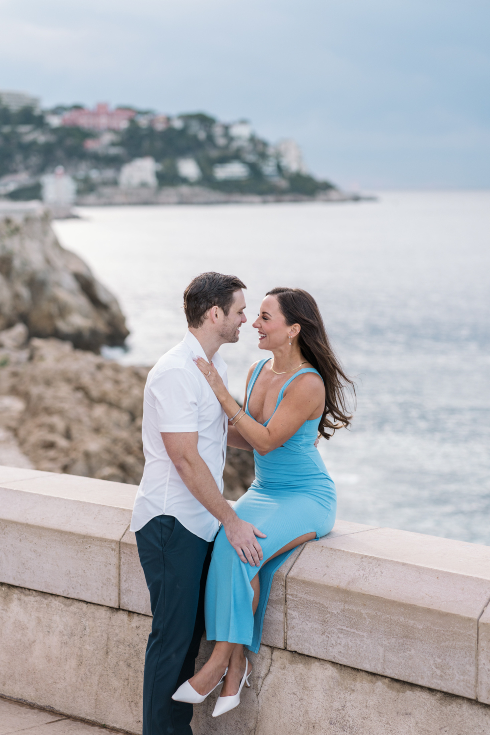 newly married couple laugh on the boardwalk in nice france