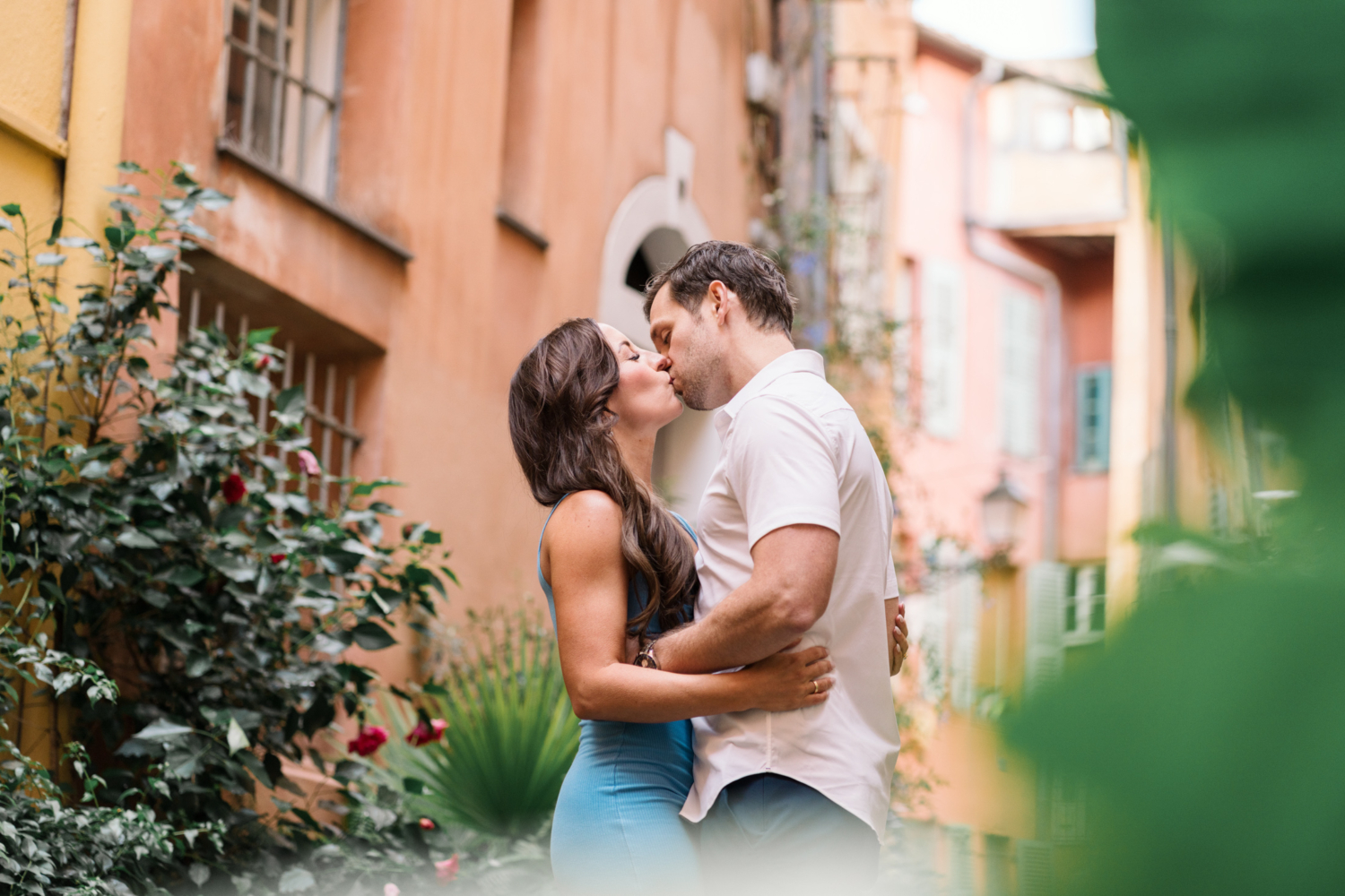 newlyweds passionately kiss amongst plants in old town nice france